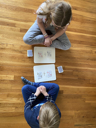 Child playing War card game recommended by boutique educational consulting firm